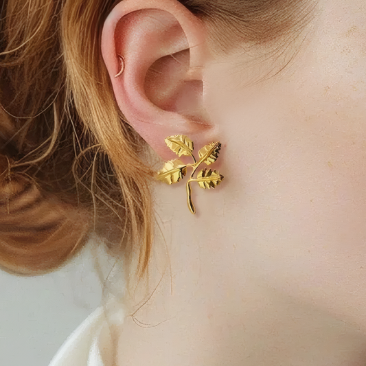 Minimal Four Leaf Cluster Earrings 18K gold plated brass close up on ear leaf texture detail