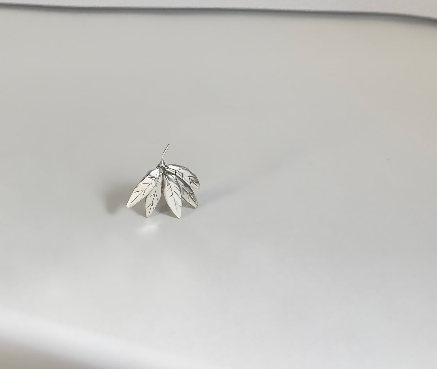 Leaf Cluster silver earrings - close-up showing engraved leaf veins and layered fan-like form | HELIGRAE handcrafted jewelry