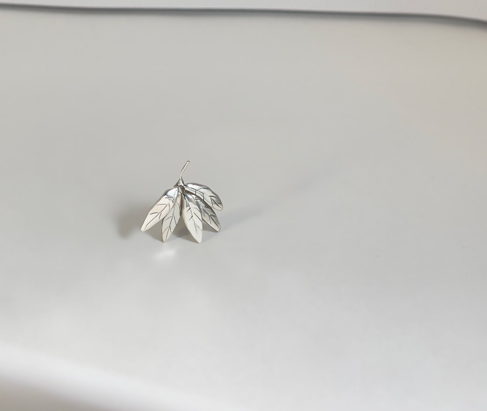 Leaf Cluster silver earrings - close-up showing engraved leaf veins and layered fan-like form | HELIGRAE handcrafted jewelry
