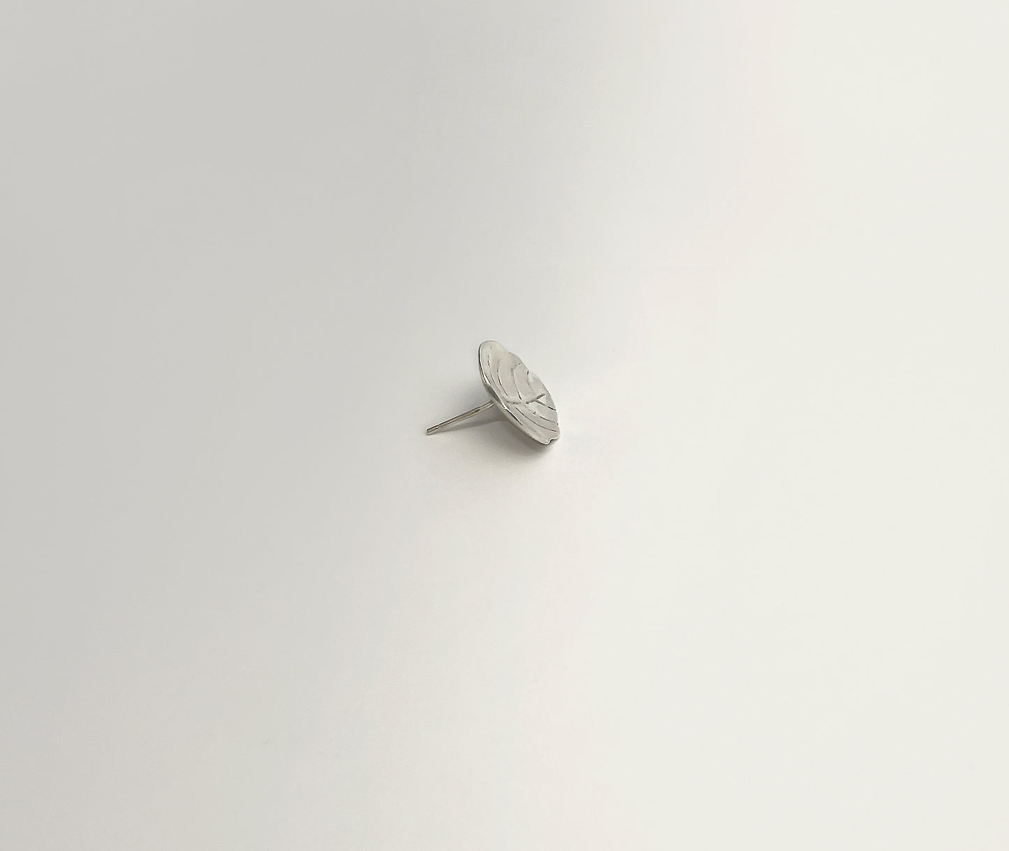  Minimalist Leaf silver studs - side angle highlighting dimensional depth and refined thickness | HELIGRAE Prototype 09