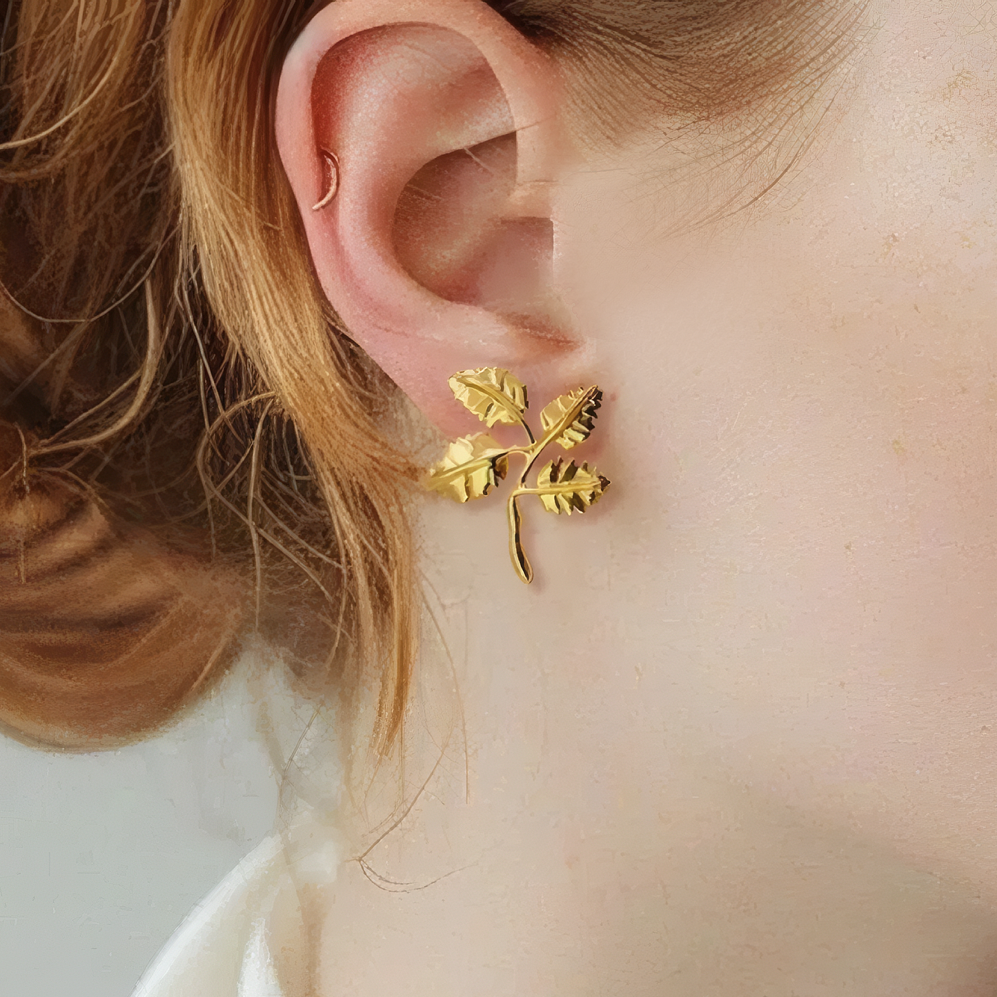 Minimal Four Leaf Cluster Earrings 18K gold plated brass close up on ear leaf texture detail