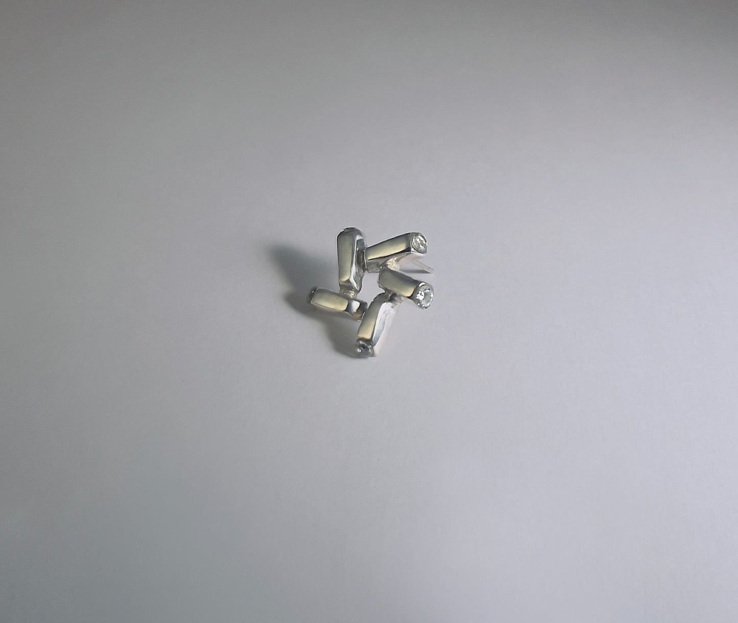 Nova Gleam geometric star earrings - macro shot highlighting engraved facets and sparkle | HELIGRAE botanical collection