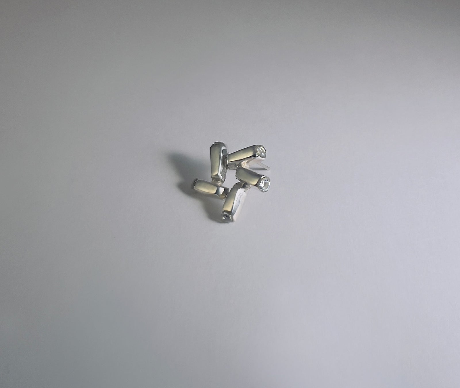 Nova Gleam geometric star earrings - macro shot highlighting engraved facets and sparkle | HELIGRAE botanical collection