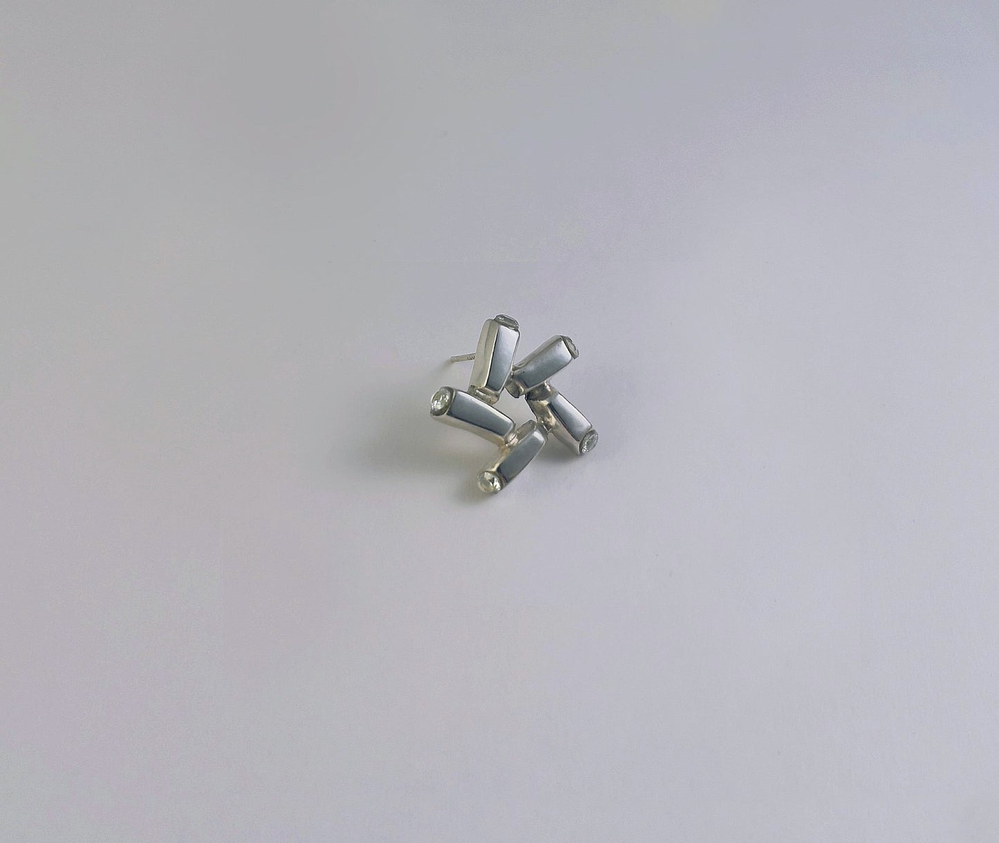 Nova Gleam star stud earrings - detailed view of polished 925 sterling silver and cubic zirconia setting | HELIGRAE