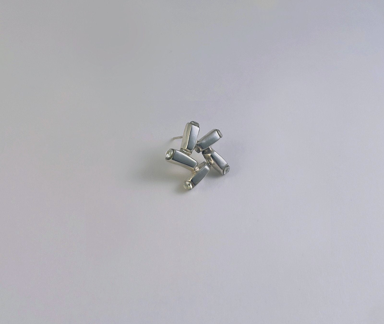 Nova Gleam star stud earrings - detailed view of polished 925 sterling silver and cubic zirconia setting | HELIGRAE