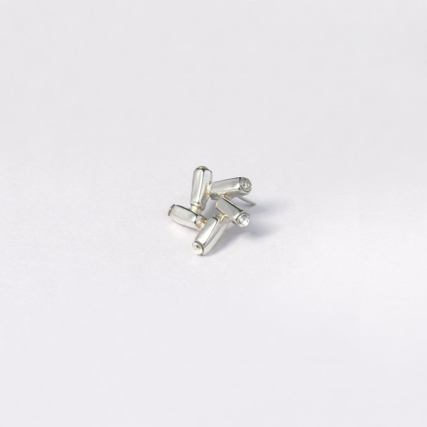 Nova Gleam geometric earrings - close-up of sculptural star form with dimensional facets | HELIGRAE handcrafted silver
