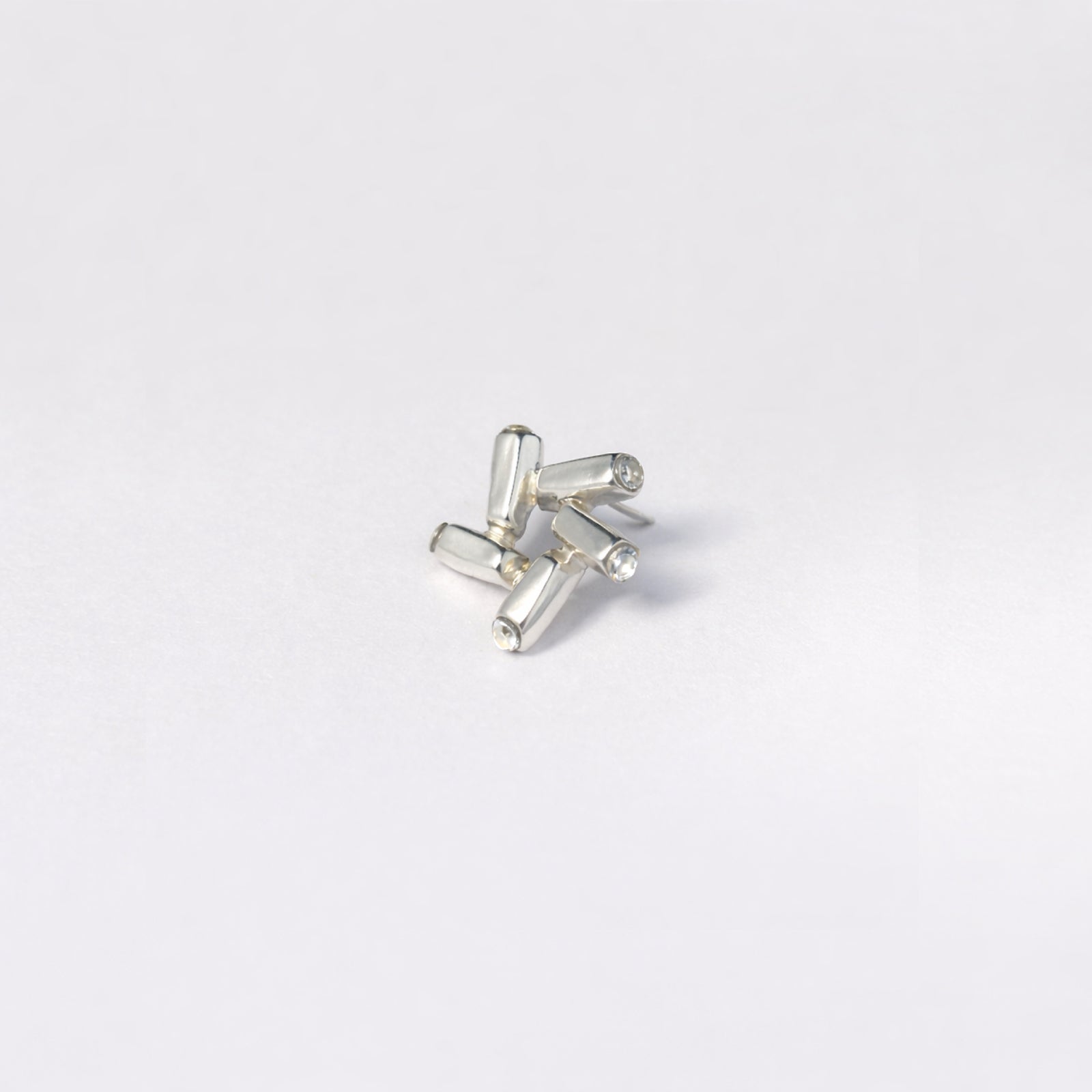 Nova Gleam geometric earrings - close-up of sculptural star form with dimensional facets | HELIGRAE handcrafted silver