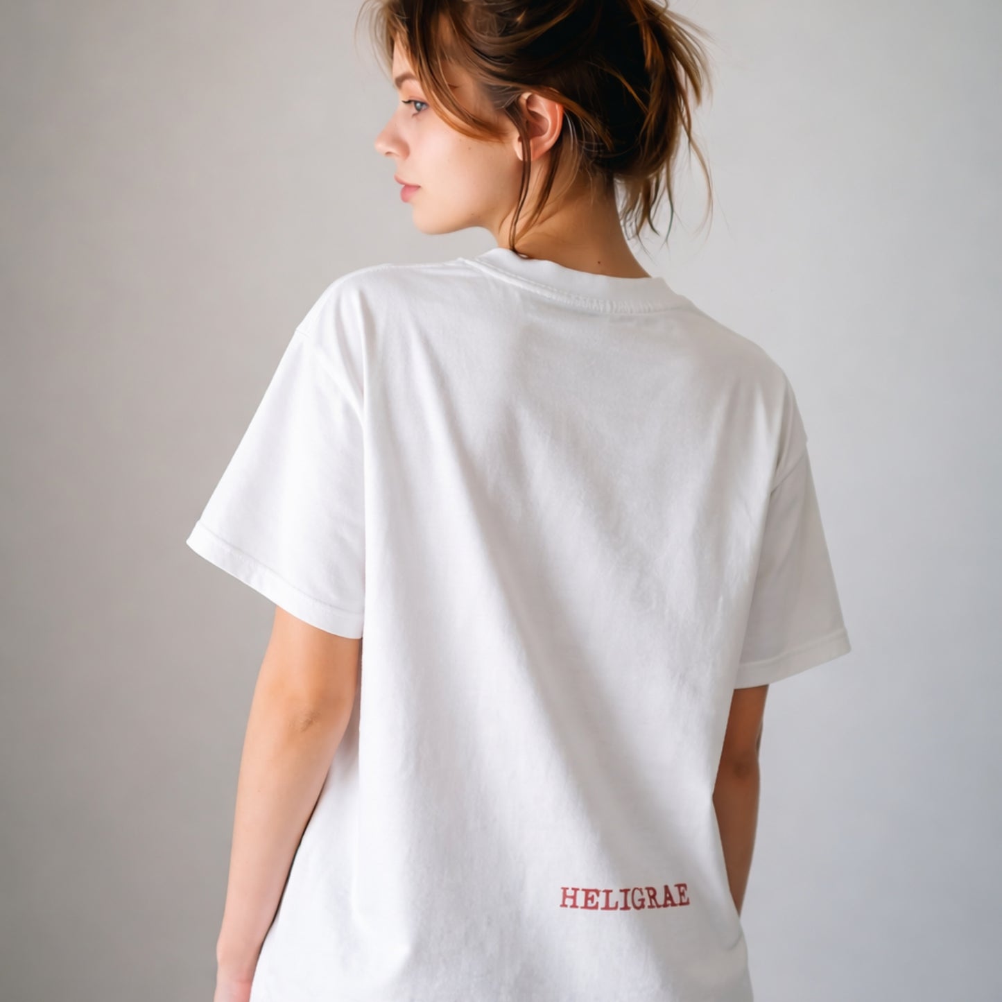 model wearing white t-shirt back minimal logo design