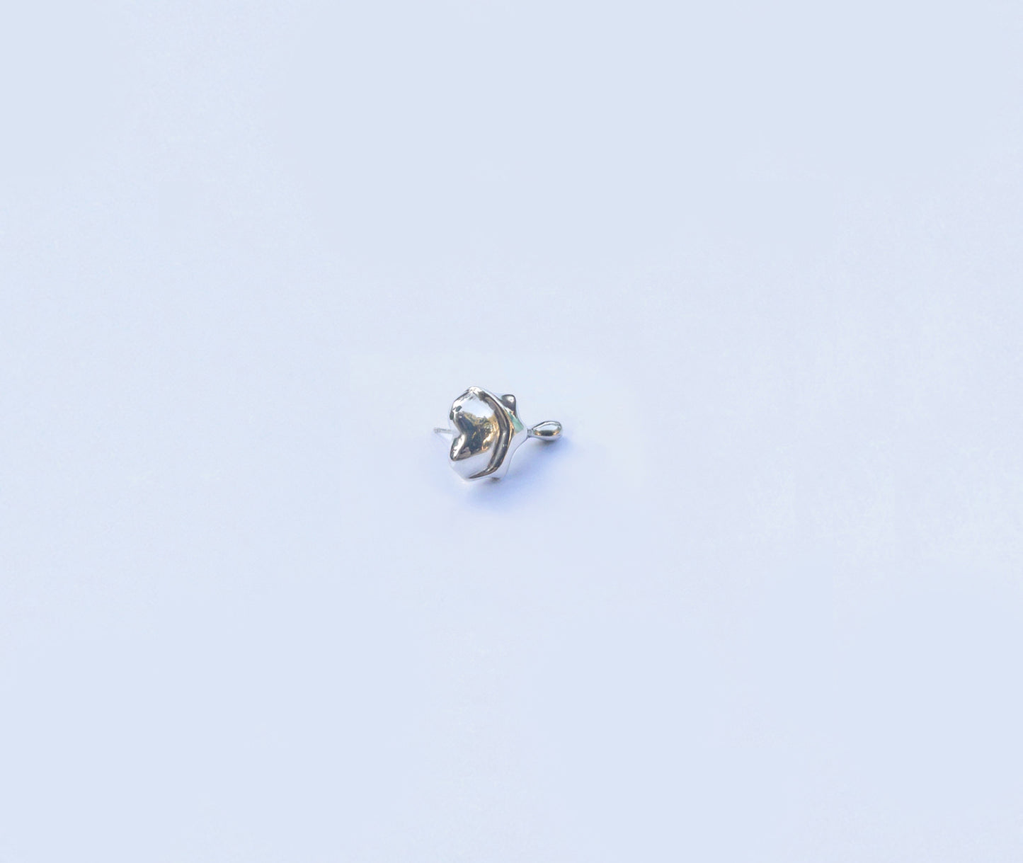  Heart-shaped silver earrings - side angle showing three-dimensional form