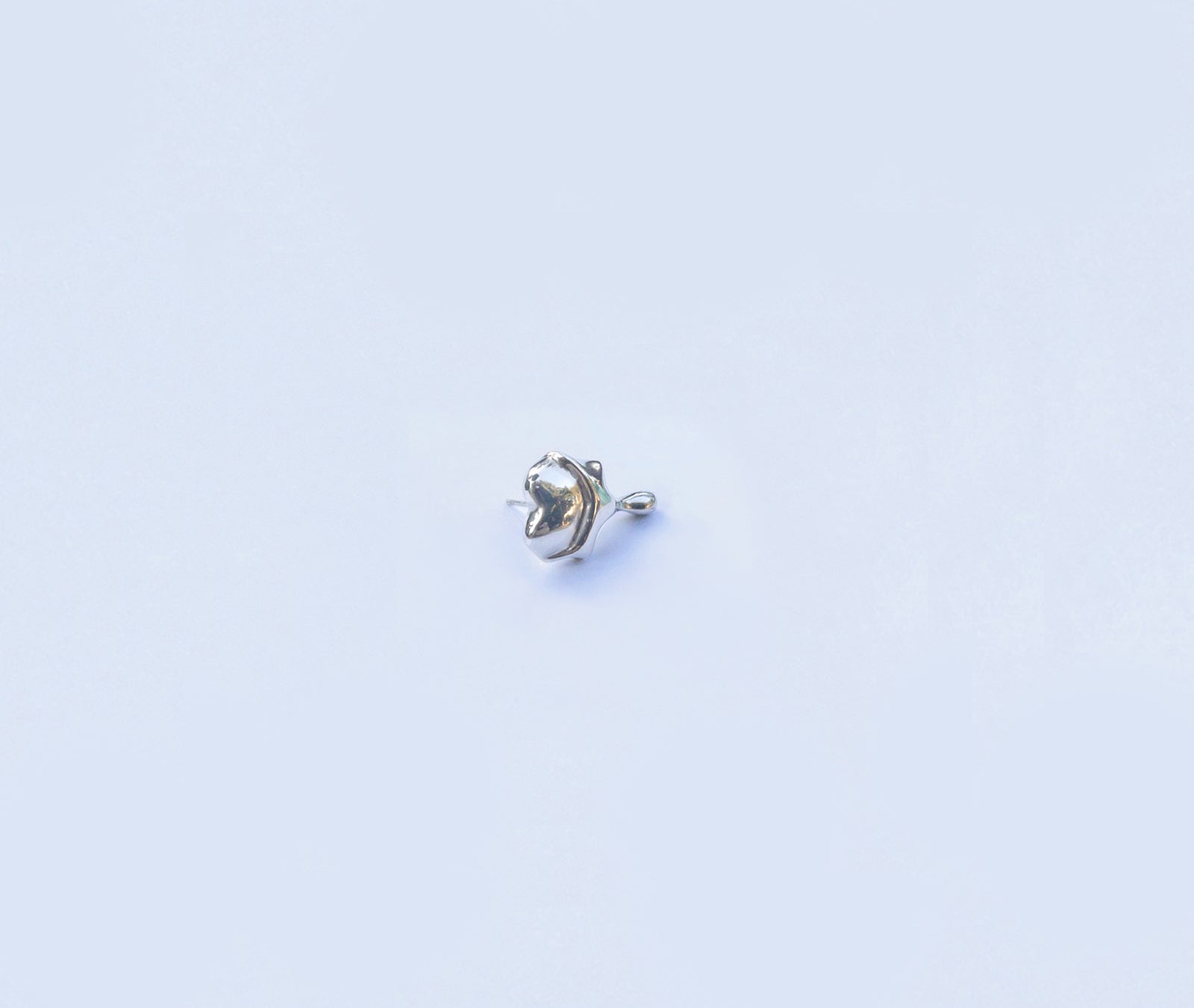  Heart-shaped silver earrings - side angle showing three-dimensional form