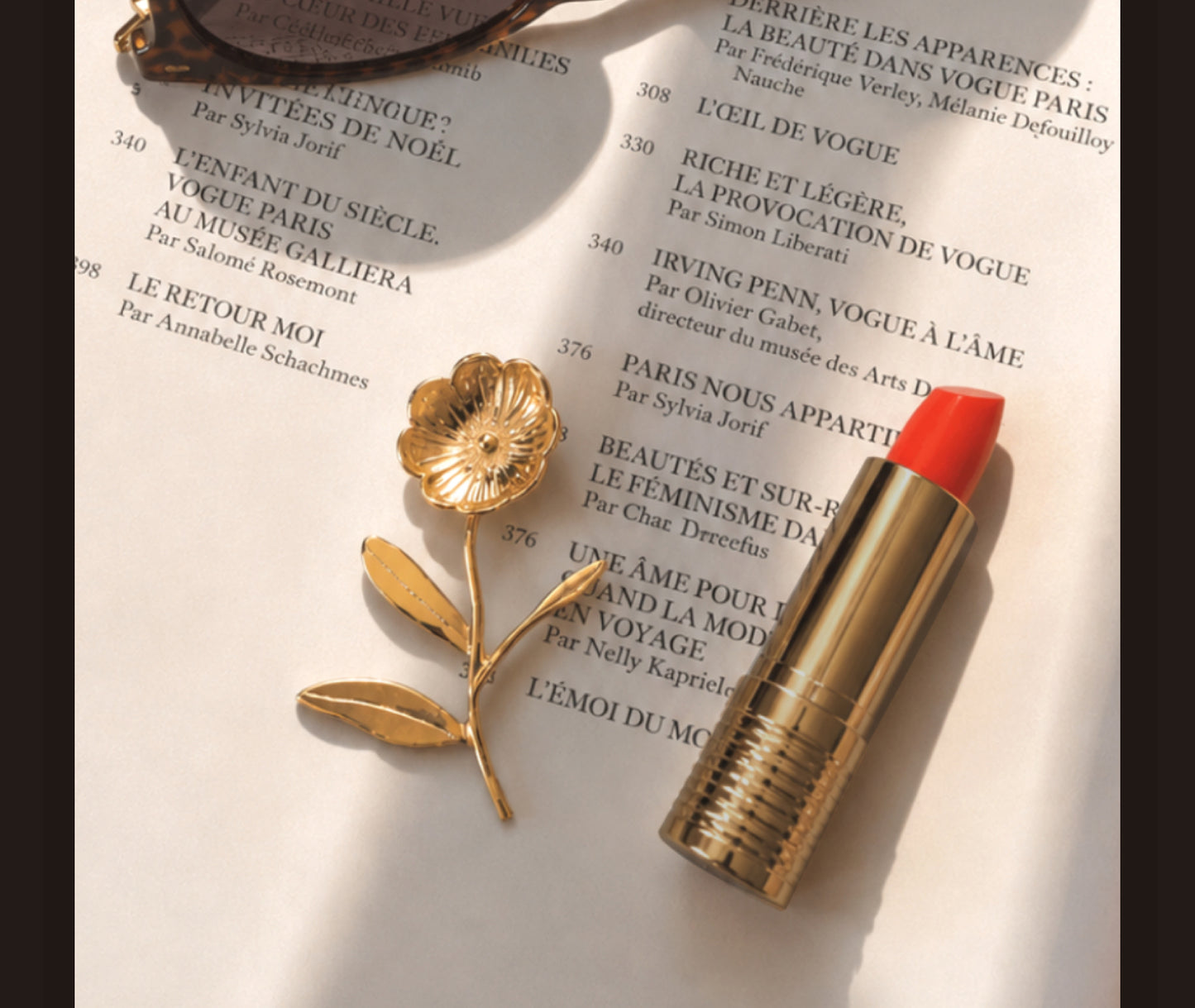 18K gold blossom stem earring with red lipstick on Vogue magazine, fashion lifestyle